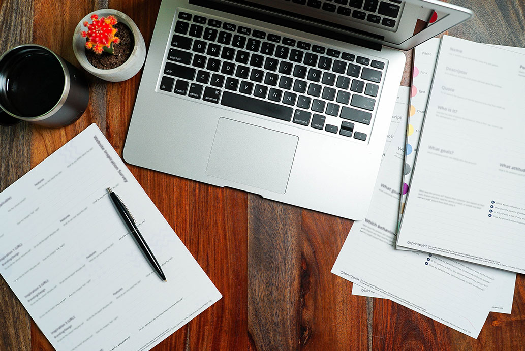 laptop with paperwork