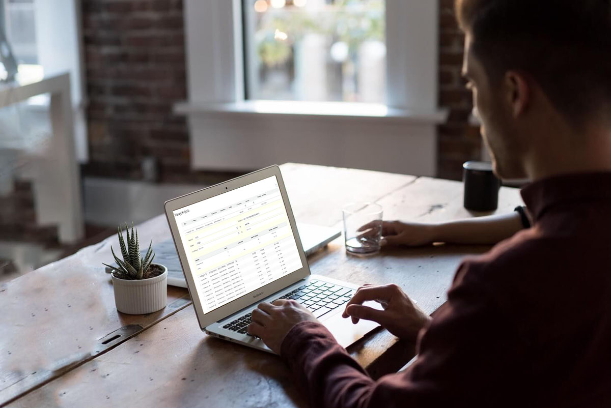 man filing rebate applications on laptop