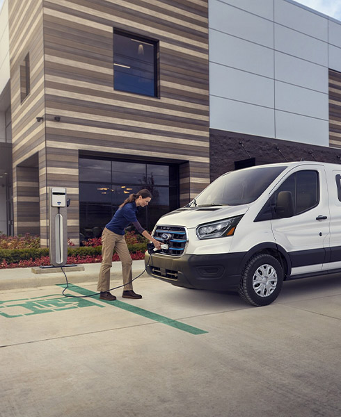 woman charging ford etransit van